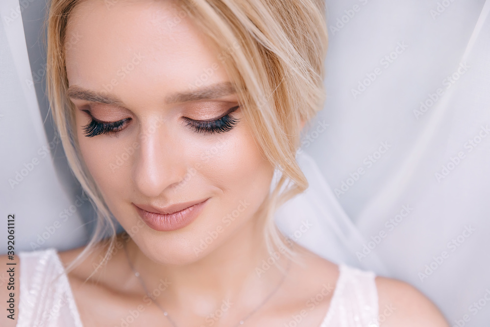 Preparing the bride for the upcoming wedding. Beautiful girl with stylish makeup and hairstyle.