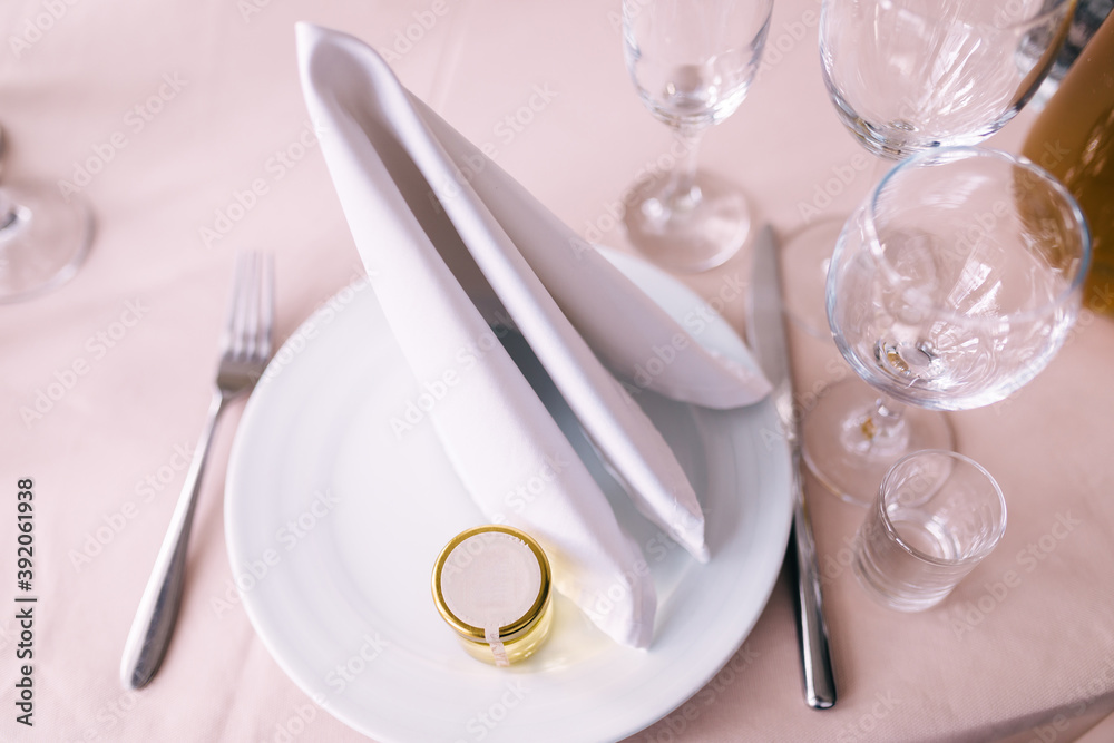 silverware and plates with silk napkins on a pink tablecloth. silverware and plates with silk napkins on a pink tablecloth.