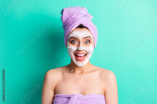 Photo of amazed crazy lady foam mask face open mouth wear purple towel turban isolated turquoise color background