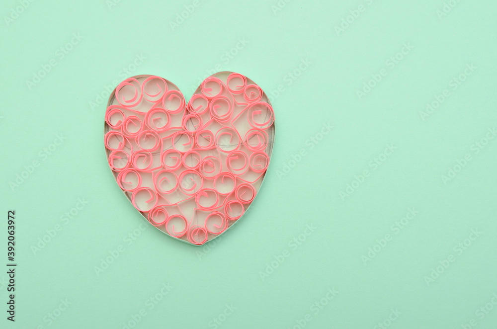 A paper heart on green background