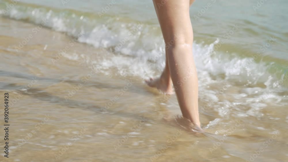 Legs walking on the beach on vacation, summer theme
Legs walking on the beach on vacation, summer theme