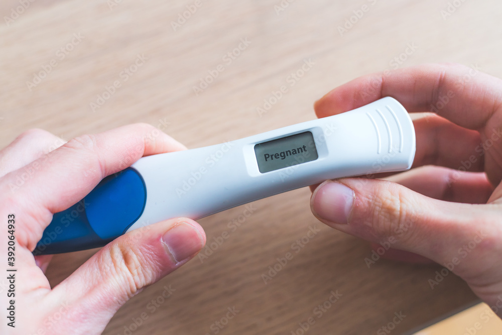 Woman checking pregnancy test. Result positive, “Pregnant” Woman checking pregnancy test. Result positive, “Pregnant”