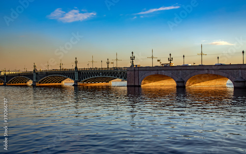 View of the Trinity bridge through Neva river on sunset in Saint Petersburg, Russia