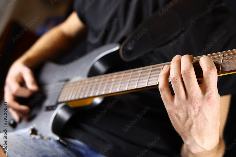 Fototapeta premium guitarist playing guitar, hands closeup