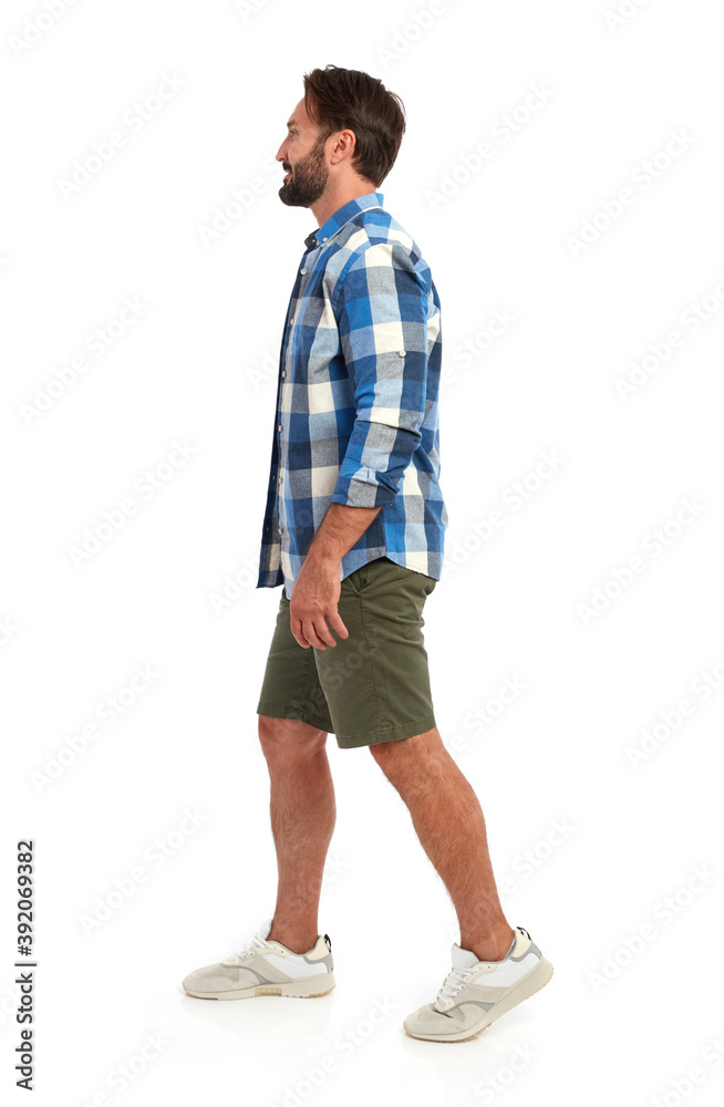 Casual man walking side view
