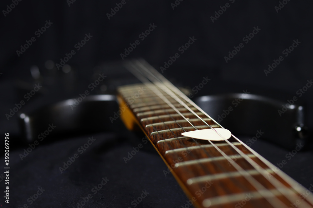 Fototapeta premium pick on the strings of the electric guitar. Selective focus