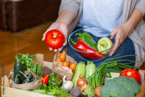 Woman choosing fresh vegetables for preparing lunch
