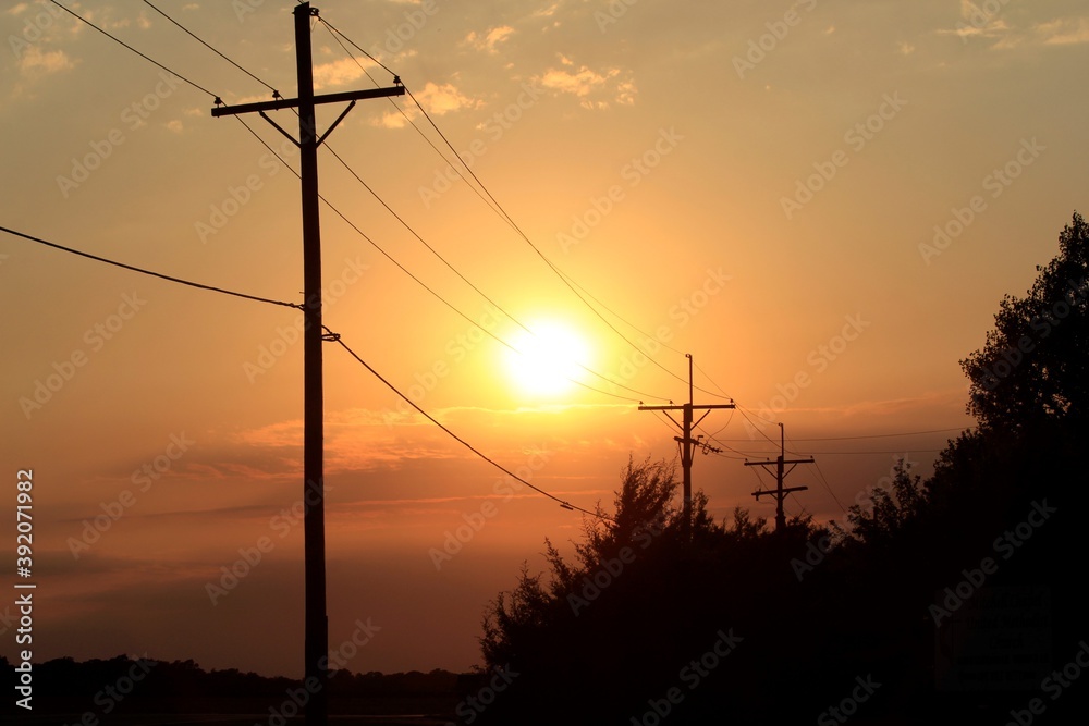 Power line silhouette's at Sunset with tree's and clouds north of Hutchinson Kansas USA out in the country. Power line silhouette's at Sunset with tree's and clouds north of Hutchinson Kansas USA out in the country.