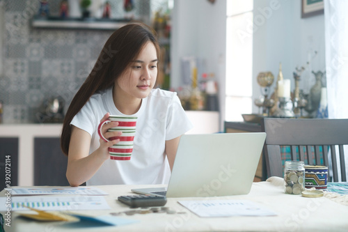 Attractive young Asia woman working at home.