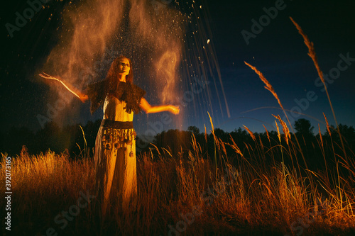Woman in halloween witch costume throws the ashes of the dead.