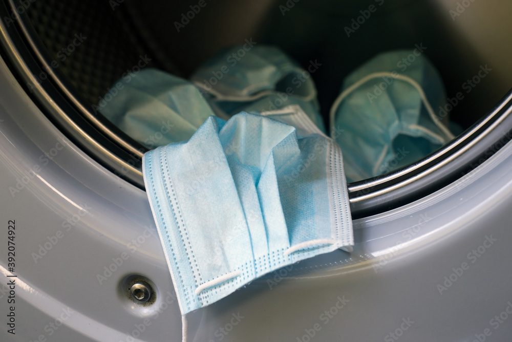 Obraz premium Closeup of medical masks in the washing machine for recycling