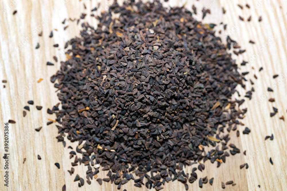 wild rue seeds on a wooden cutting board wild rue seeds on a wooden cutting board