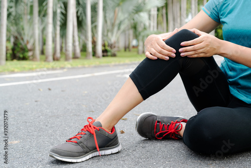 fitness woman runner feel pain on knee. Outdoor exercise activit photo