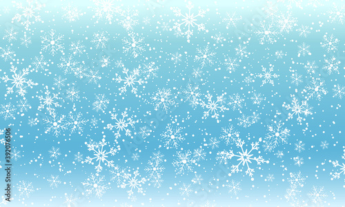Snow background. Winter snowfall. White snowflakes on blue sky. Christmas background. Falling snow.