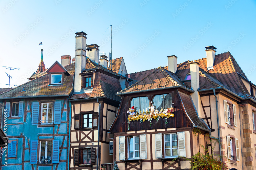 Fototapeta premium Traditional Alsatian half-timbered houses and river Lauch in Petite Venise or little Venice, old town of Colmar, decorated and illuminated at christmas time, Alsace, France