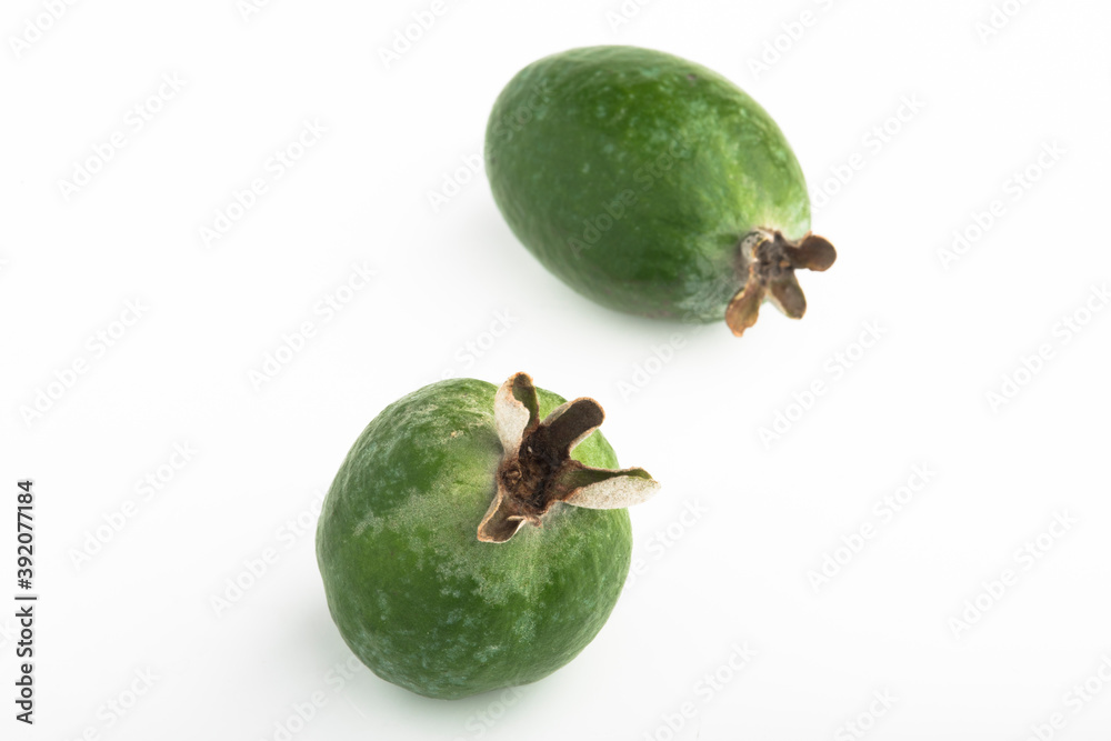 Green feijoa fruit on an isolated white background. Green feijoa fruit on an isolated white background.