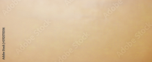 Old brown paper parchment background design with distressed vintage stains and ink spatter and white faded shabby center, elegant antique beige color