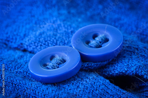 Two blue buttons of a vibrant blue jumper