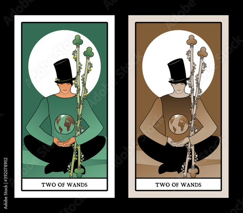 Two of wands. Tarot cards. Young man sitting, wearing hat looking at a globe.