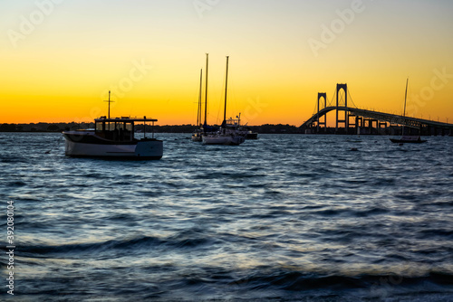 Boats near Pell Bridge in Newport at sunset.