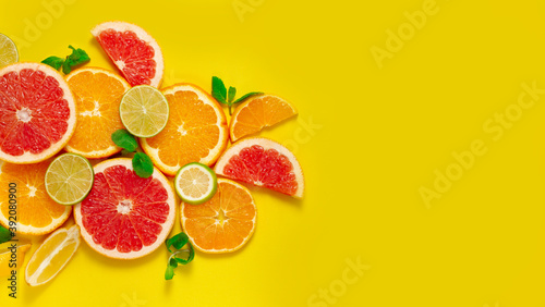 assortment of citrus fruits  on a yellow background  top view  no people  horizontal 