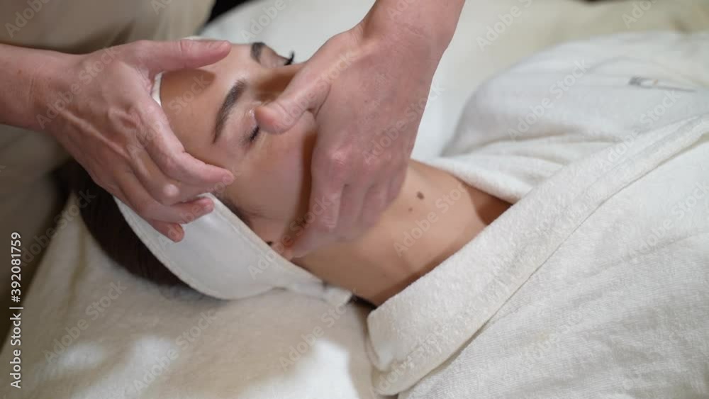 woman doing facial massage. close-up. massage parlour woman doing facial massage. close-up. massage parlour
