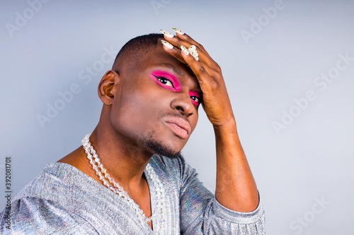 brazilian gender fluid male dressed as female with gorgeous make up in studio white background photo