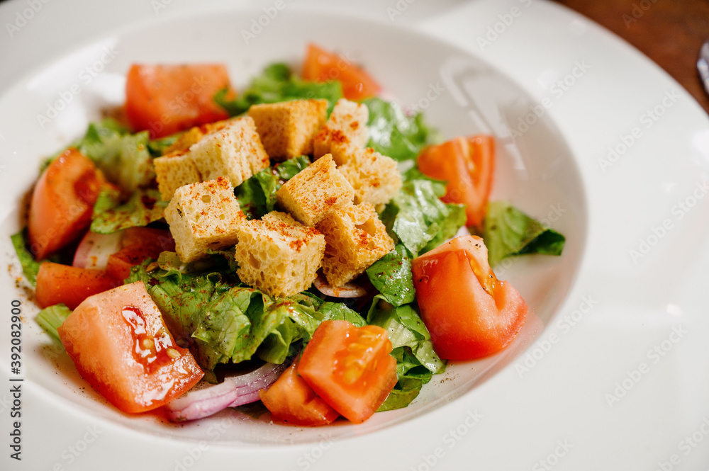 Caesar salad with croutons, quail eggs, cherry tomatoes and grilled chicken in wooden table Caesar salad with croutons, quail eggs, cherry tomatoes and grilled chicken in wooden table