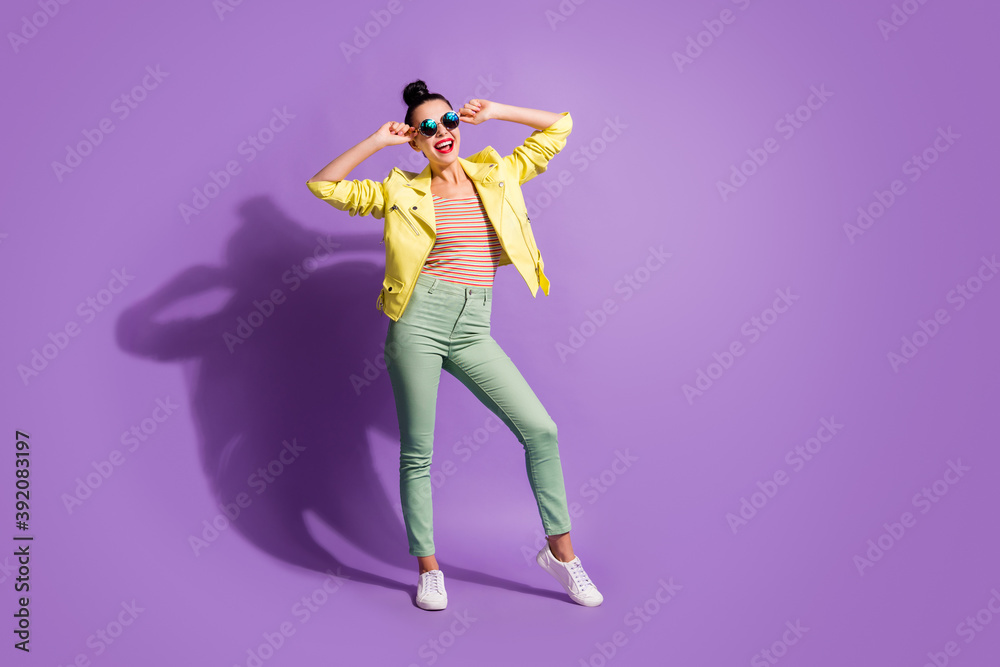 Full body photo of young beautiful girl enjoy happy smile hands touch sunglass isolated over violet color background