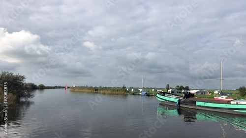 Skutsje passing by during autumn around Gaastmeer in Friesland The Netherlands photo