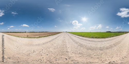 Full spherical seamless hdri panorama 360 degrees angle view on no traffic white sand gravel road among fields with clear sky in equirectangular projection, VR AR content
