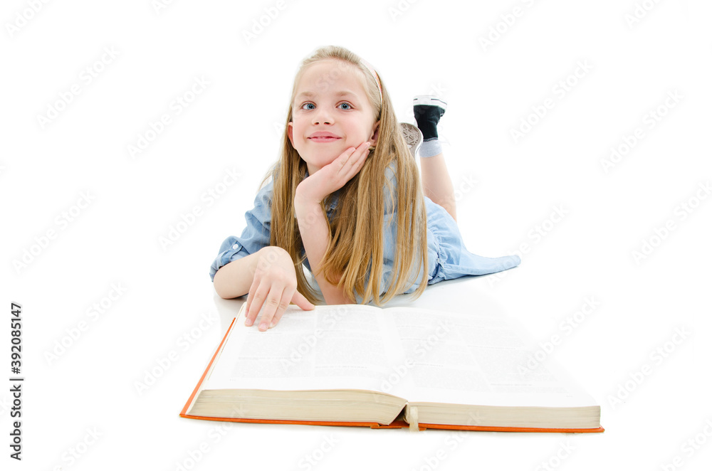 Education and school concept - adorable girl lying on floor and reading ...