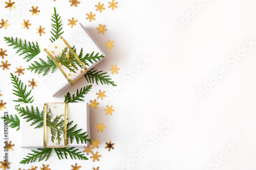 Christmas white and gold background with gifts, green twigs and stars