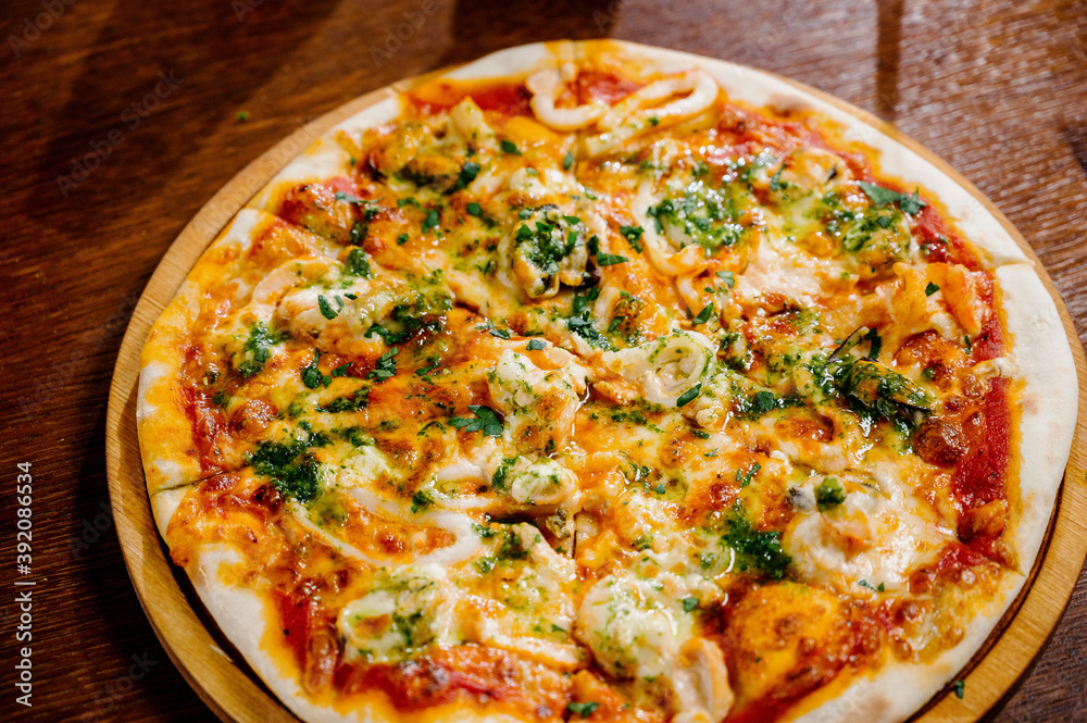 Delicious Shrimp pizza on wood table