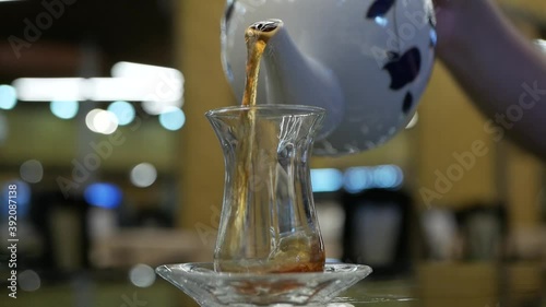 turkish glass of black tea on bokeh background photo