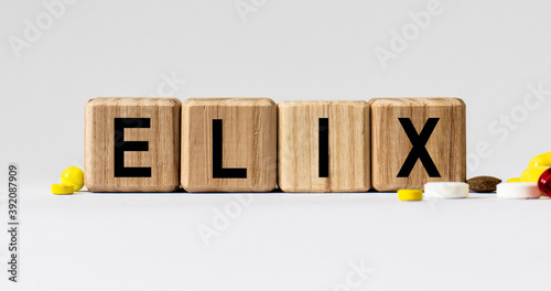 cubes with the word ELIX on them. Care concept. photo