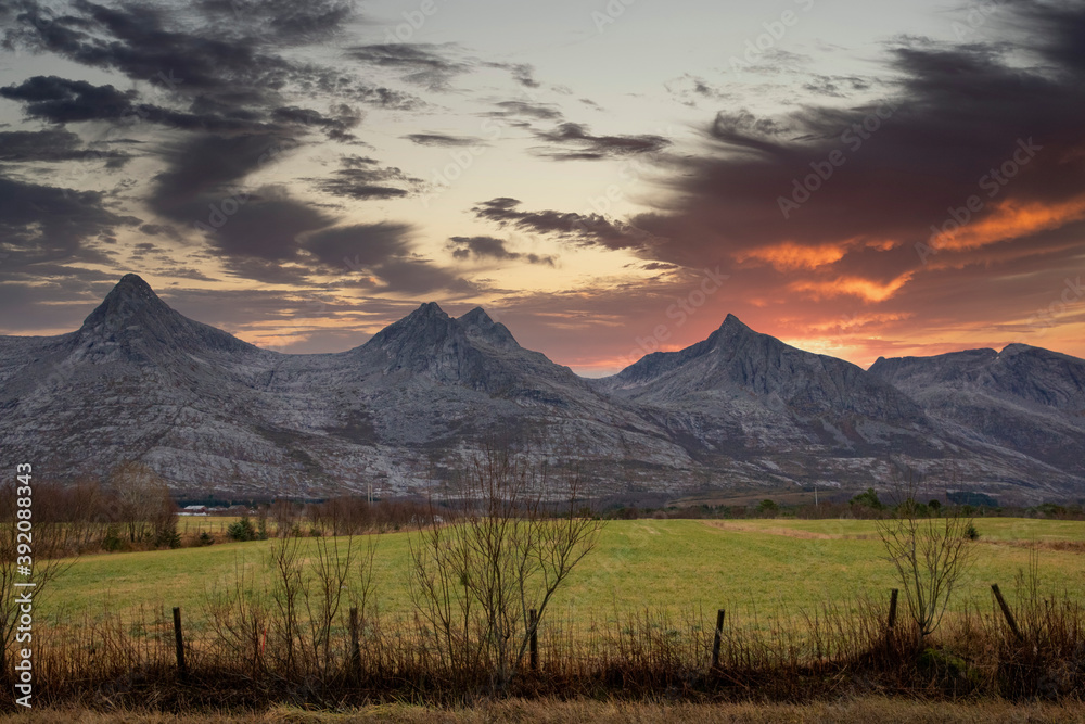 Fototapeta premium Sunset in the mountains seven sisters ( here three of the sisters )in Alstadhaug municipality,Helgeland,Nordland ,Norway,scandinavia,Europe