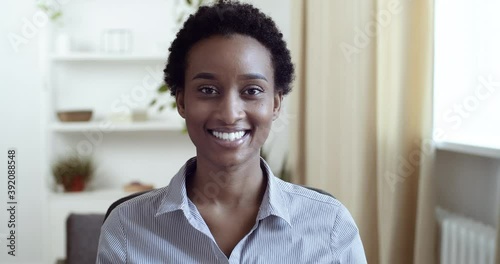 Portrait african american business woman cute lady student model toothy smiling in home office indoor, beautiful female executive enjoying successful career looking at camera, happy black female gace photo