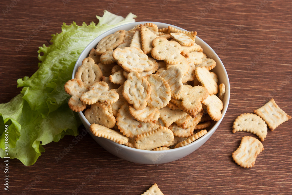 delicious dry cookies, biscuits, crackers with salt and herbs in a clay bowl
