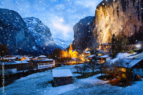 amazing touristic alpine village at night in winter with famous church and Staubbach waterfall  Lauterbrunnen  Switzerland  Europe © Melinda Nagy