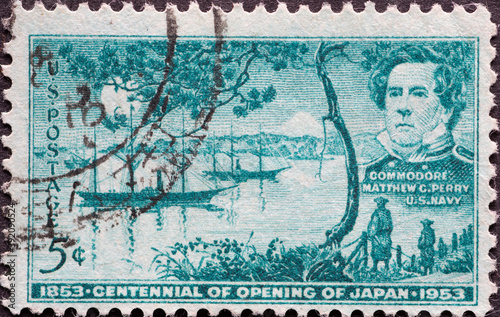 USA - Circa 1953 : a postage stamp printed in the US showing a portrait by Commodore Matthew Perry and a landscape with historical ships Text: Centennial Opening of Japan