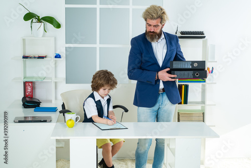 Little boss. Little Businessman bossy child working in office.