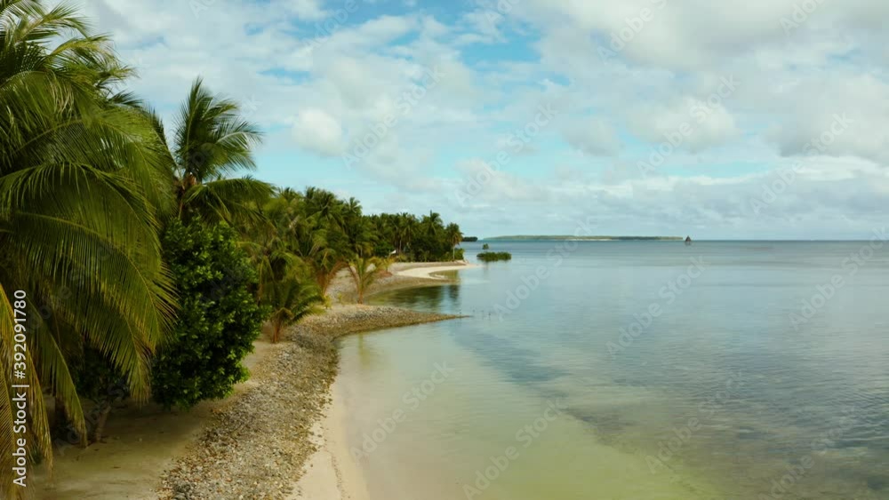 Tropical sandy beach with palm trees and blue water, top view. Summer and travel vacation concept. Siargao,Philippines. Tropical sandy beach with palm trees and blue water, top view. Summer and travel vacation concept. Siargao,Philippines.
