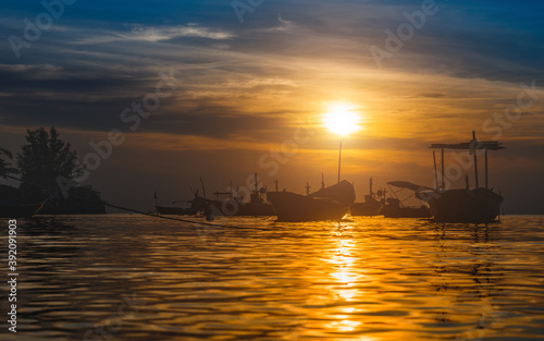 Silhouette fishery boats in the sunset time.