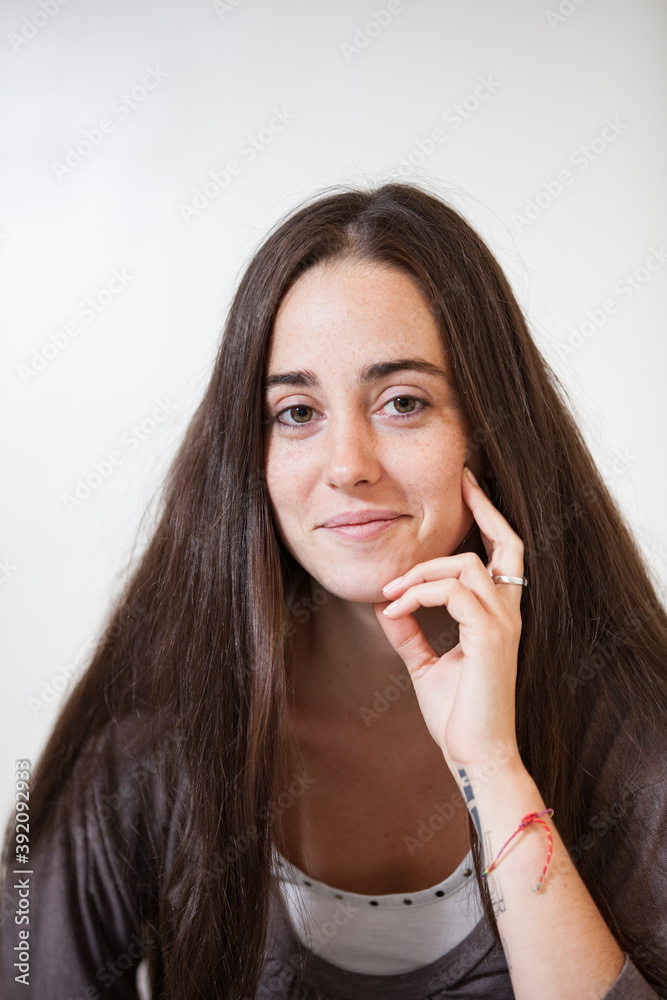 Portrait of a young and sweet natural woman without makeup with long brown hair Portrait of a young and sweet natural woman without makeup with long brown hair