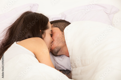 Portrait of a young couple in love in a bed
