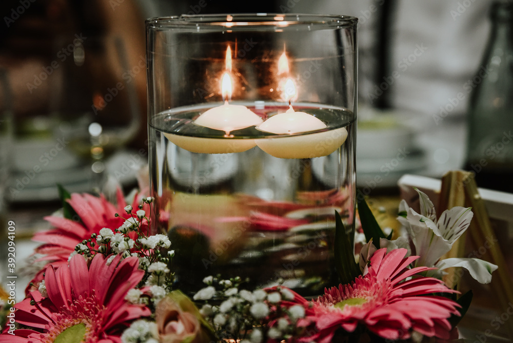 christmas decoration with candle. Centerpiece with natural flowers, candles and water