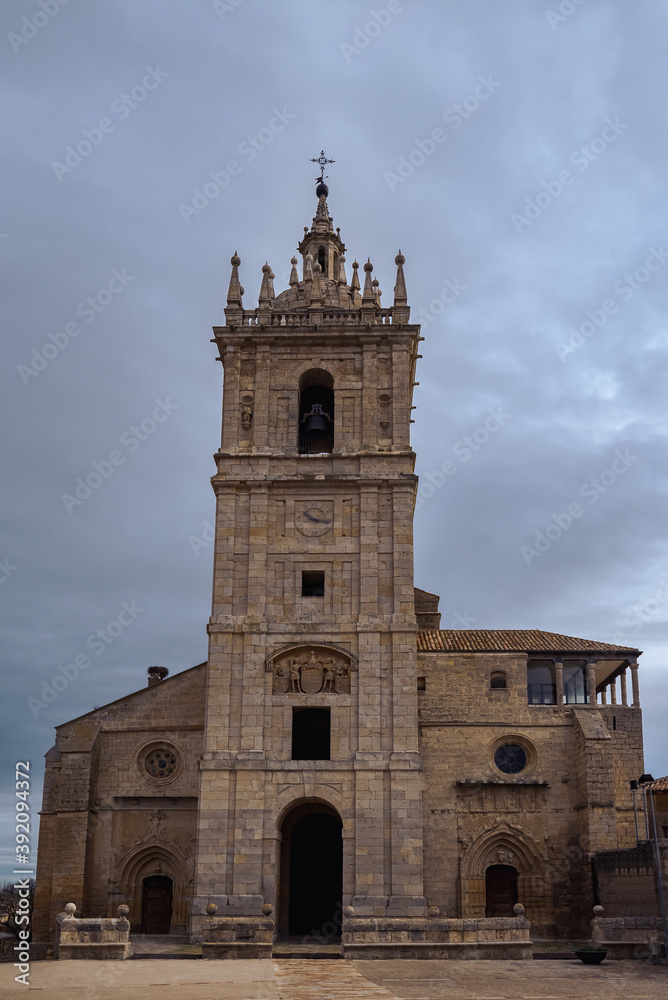 old gothic style catholic church front view with a dramatic sky in palencia, spain