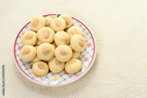 Картината върху платно Graibe a buttery Arab biscuit with an almond on a plate