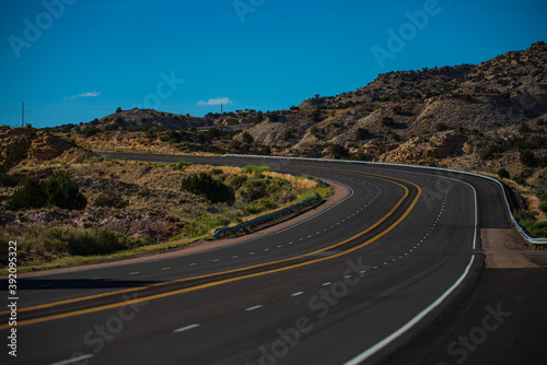 Asphalt highway and hill landscape under the blue sky. Road in America. © Volodymyr